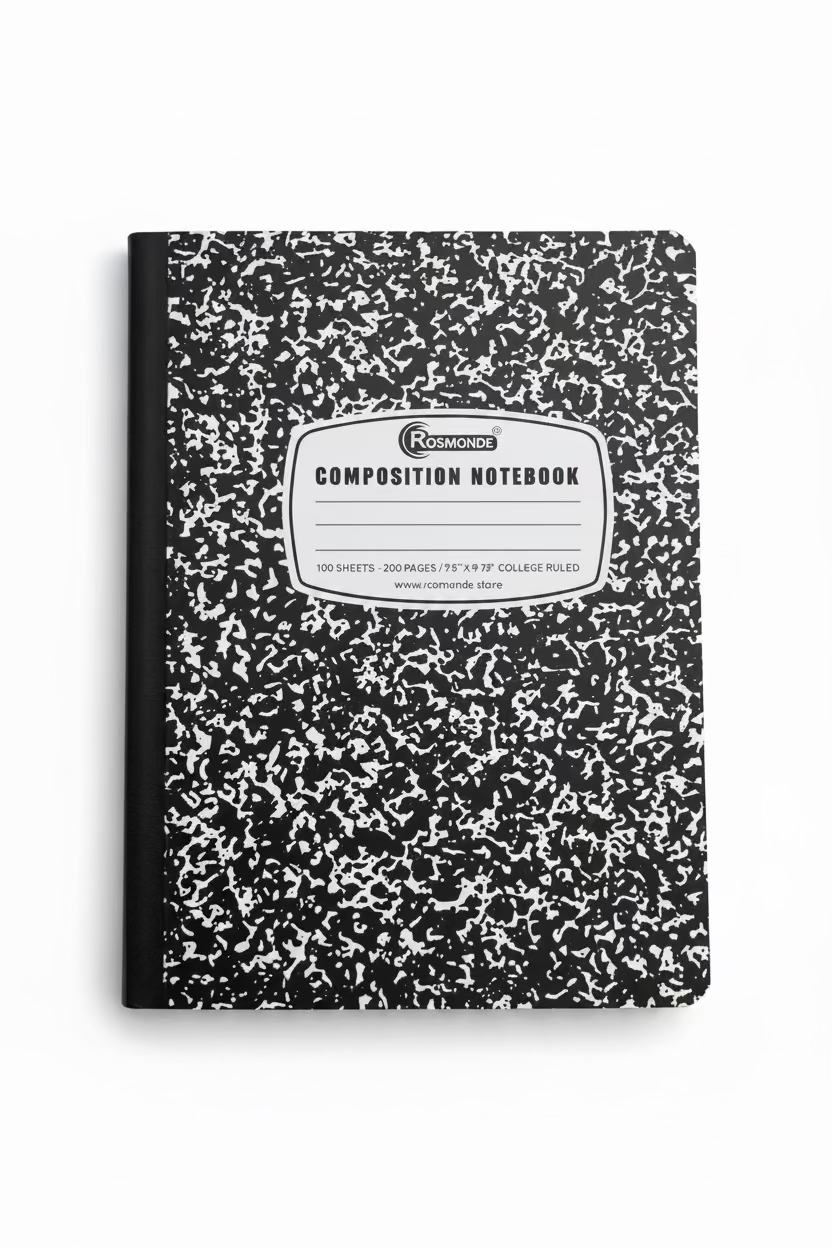 Composition notebook with black and white speckled pattern on a light background